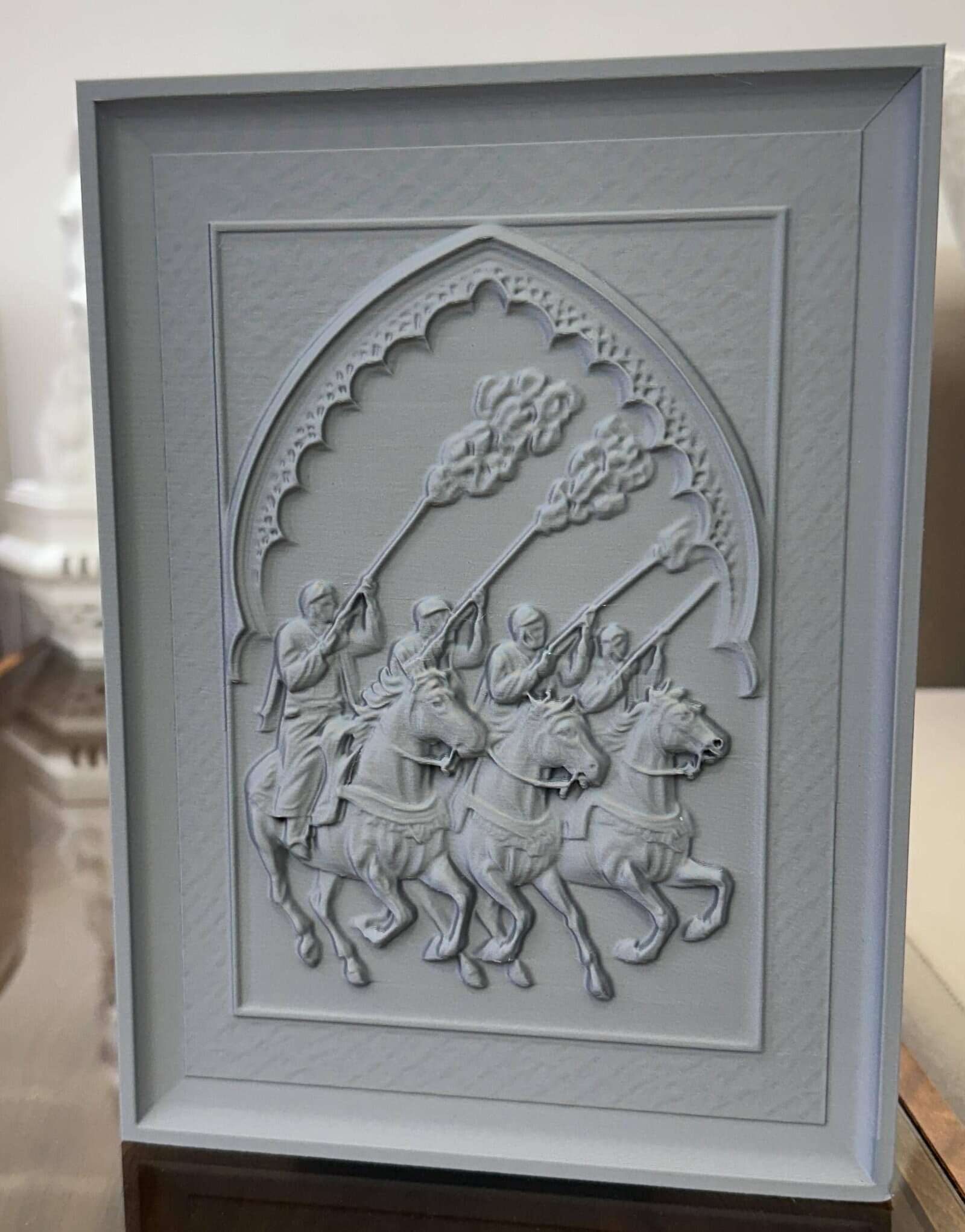 IMG_1560 Customizable 3D-printed Fantasia Horsemen Relief Sculpture featuring Moroccan riders in synchronized charge, framed in traditional Moorish arch.